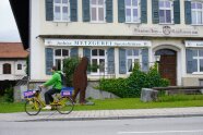 Radfahrer vor einem großen Gasthaus