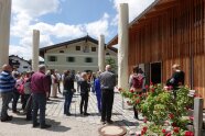 Tagungsteilnehmer versammeln sich um einen Dorfplatz