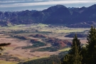 Blick auf das herbstlich gefärbte Naturschutzgebiet Murnauer Moos mit den bayerischen Alpen im Hintergrund.